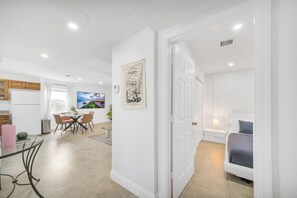 2 habitaciones, escritorio y tabla de planchar con plancha