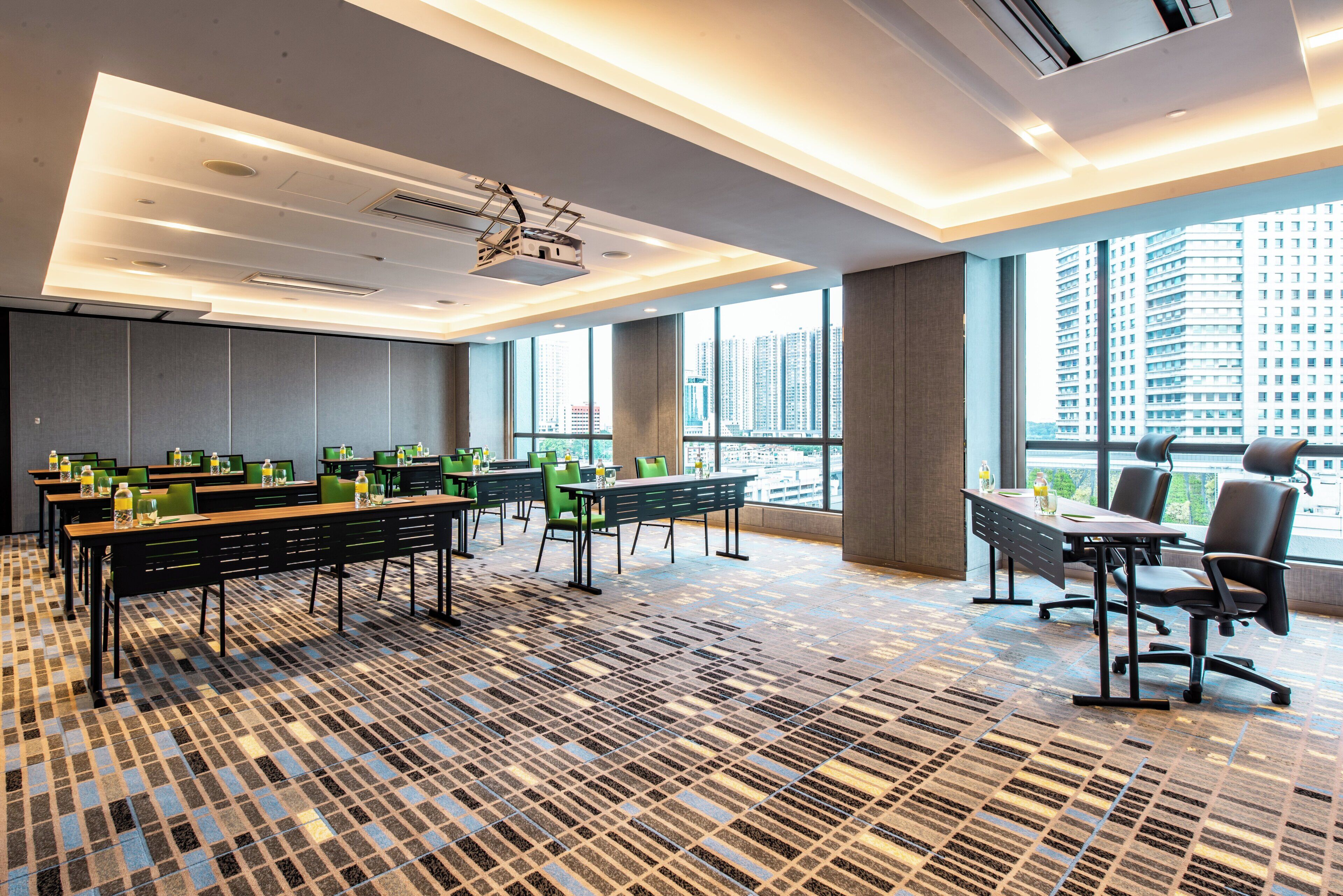 A conference room with a large table, chairs, and a projector.