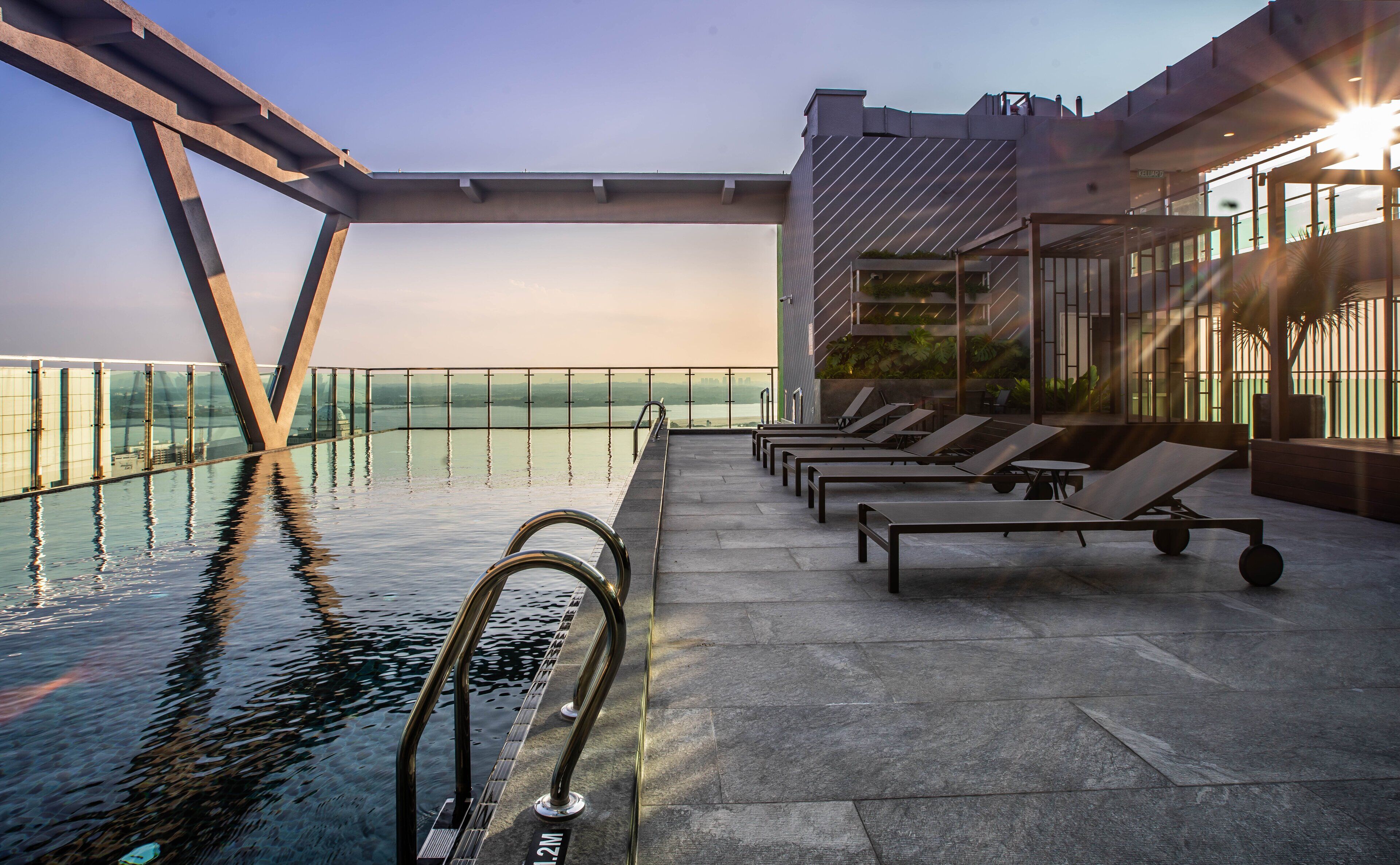 Outdoor pool, open 7:00 AM to 8:00 PM, pool loungers