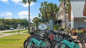A bicycle parking area with a sign reading "Peddlers Pavilion" and a beach sign indicating "Seacrest Beach 30A". - A Slice Of Paradise! Beautiful Ocean Views And Just Steps From The Beach (Panama City Beach)