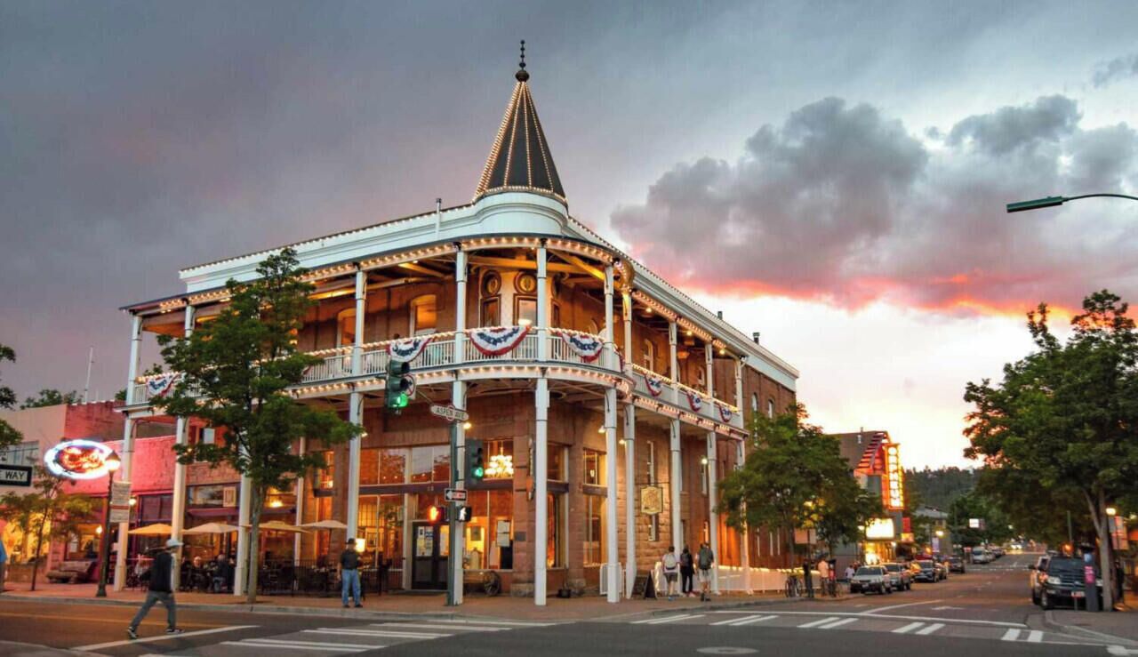 A historic building with a balcony, located in a downtown area.