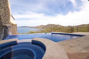 A swimming pool with a view of the sea and hills. - Mariners Point - C1 (Sardinal)