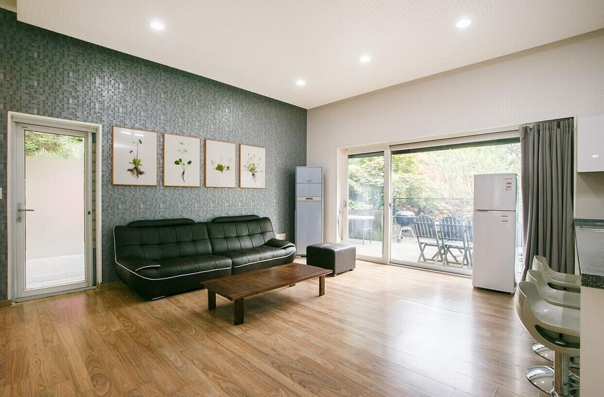 Suite (Gray) | Living area | Flat-screen TV, heated floors