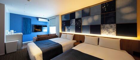 A hotel room with two beds, a desk, a TV, and a wall with a cityscape design.