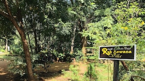 A sign for Ruk Sewana Villa, surrounded by lush greenery and trees. - Ruk Sewana Villa (Sigiriya)