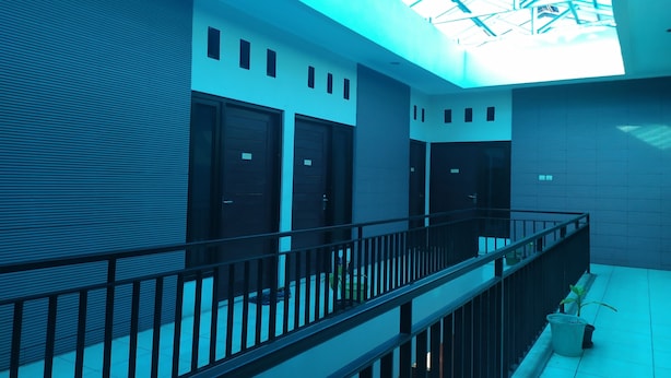 A modern building with a glass ceiling, metal railings, and a tiled floor. - OYO 2654 Yulia Guesthouse Near Kopi Bajawa Flores NTT Tebet (Jakarta)