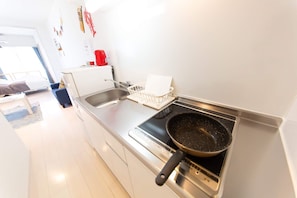 Kitchen area with stove, sink, and appliances.