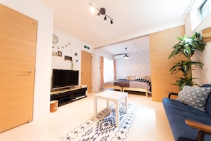 Relax in this inviting living room with a flat-screen TV, coffee table, and comfortable sofa.
