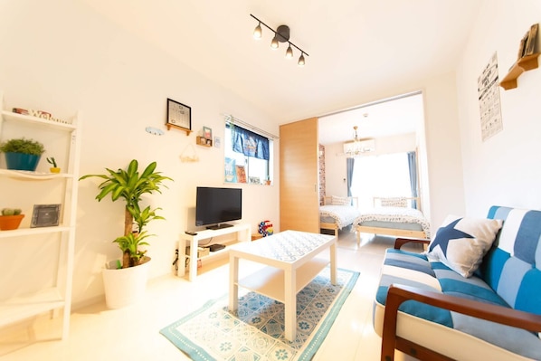 Relax in this stylish living room with a comfortable sofa, coffee table, and large potted plant.