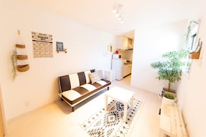 Relax in this stylish living room with a sofa, coffee table, and patterned rug.