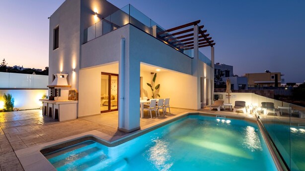 A modern house with a swimming pool, outdoor seating, and a pergola. - Villa Oriens in Gennadi (Rhodes)