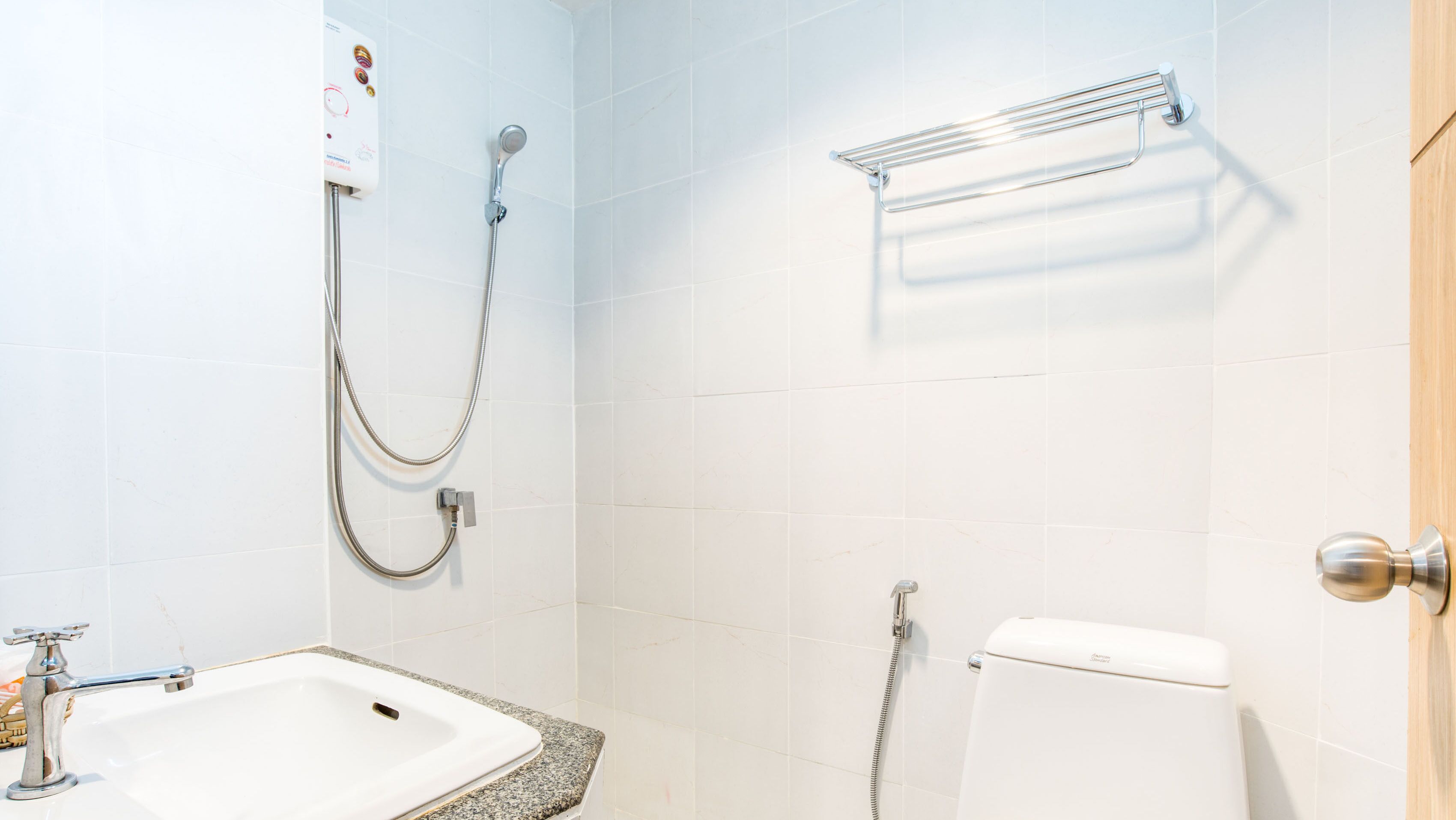 A bathroom with a sink, toilet, and shower.