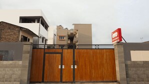 A gated entrance with a modern building in the background.