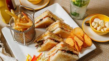 A plate of sandwiches, French fries, and chips.