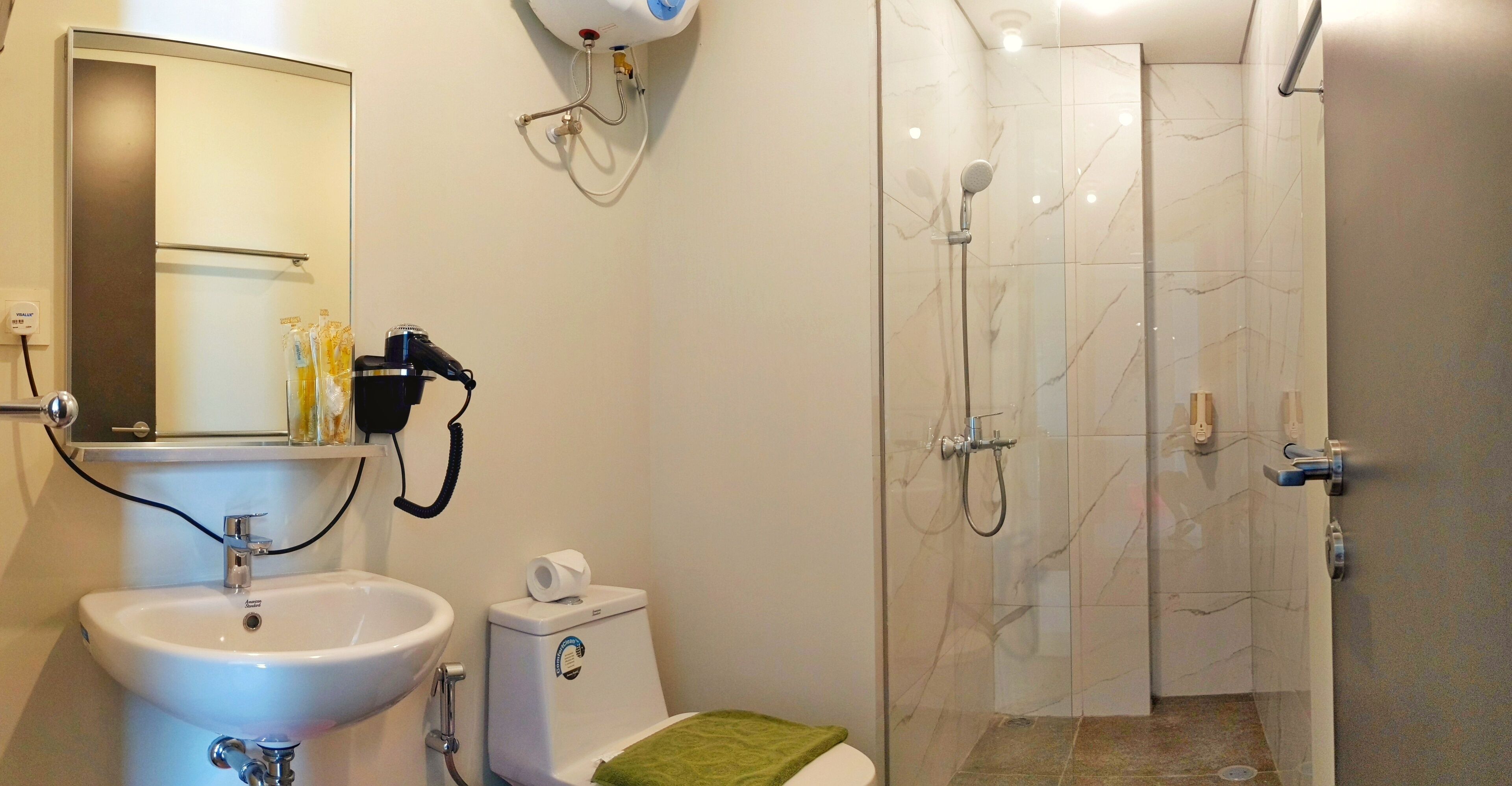 A bathroom with a sink, toilet, and shower.