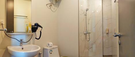 A bathroom with a sink, toilet, and shower.