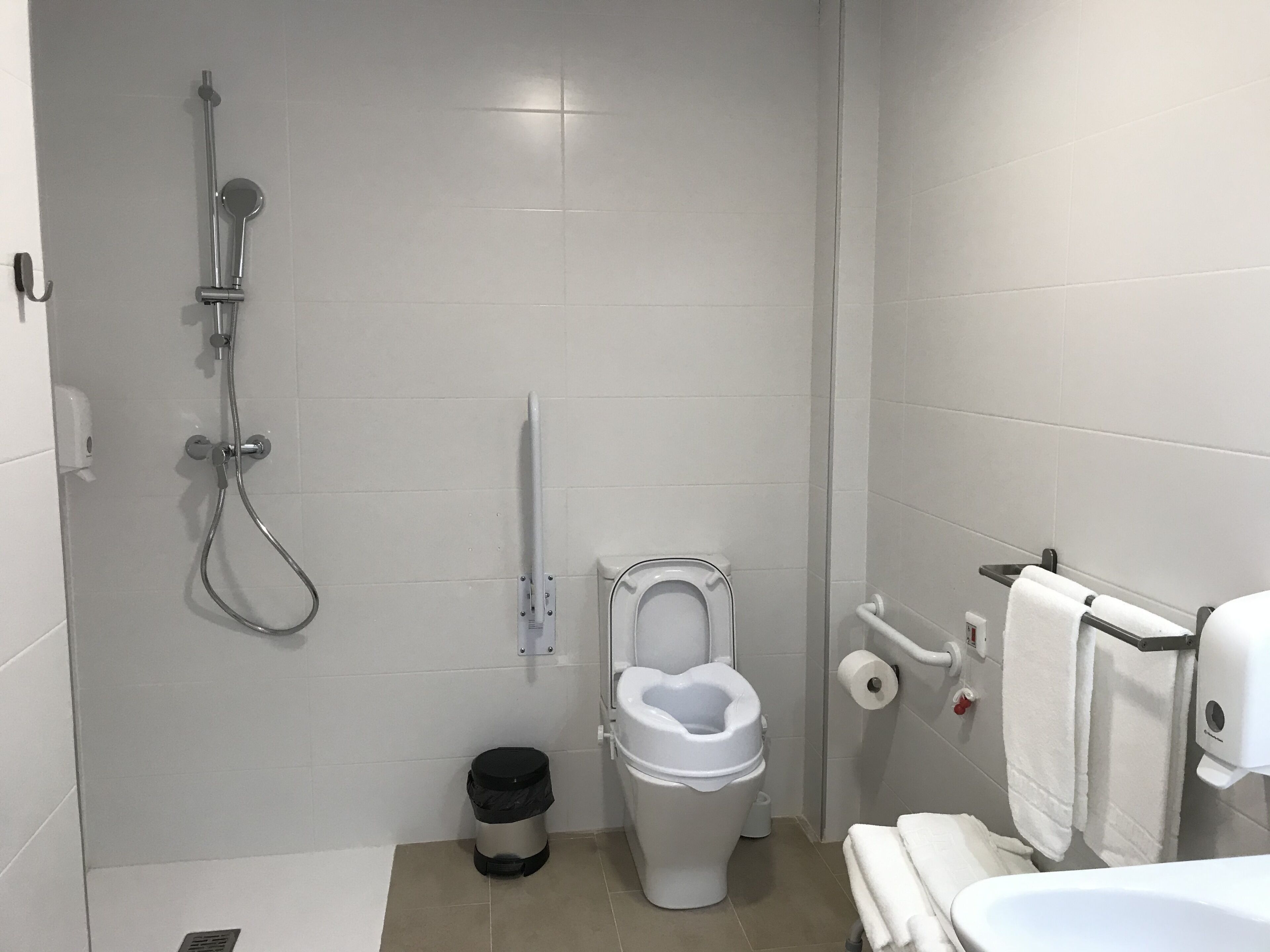 A bathroom with a toilet, bidet, and shower.