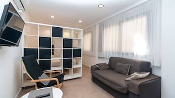 Apartment, 1 Bedroom | Living area | 32-inch flat-screen TV with satellite channels
