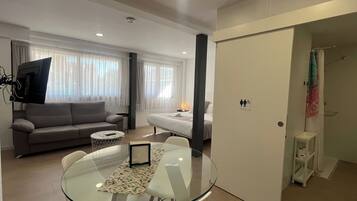 Estudio familiar, varias camas | Zona de estar | Televisión de pantalla plana de 32 pulgadas con canales por satélite