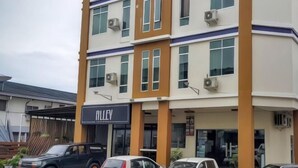 A multi-story building with a sign reading "MILLEY". - Residence 21 Boutique Inn (Miri)