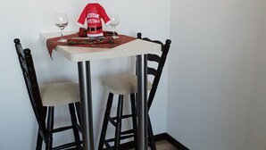 A dining table with a red and white Santa Claus decoration, a glass, and a white tablecloth. - Royal Bansko Aparthotel - 1 Bed Sleeps 4 (Bansko)