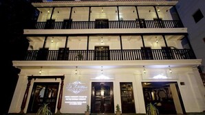 A multi-story building with balconies and a sign that reads "Le Chateau." - Le Chateau - A Heritage Boutique Hotel (Pondicherry)