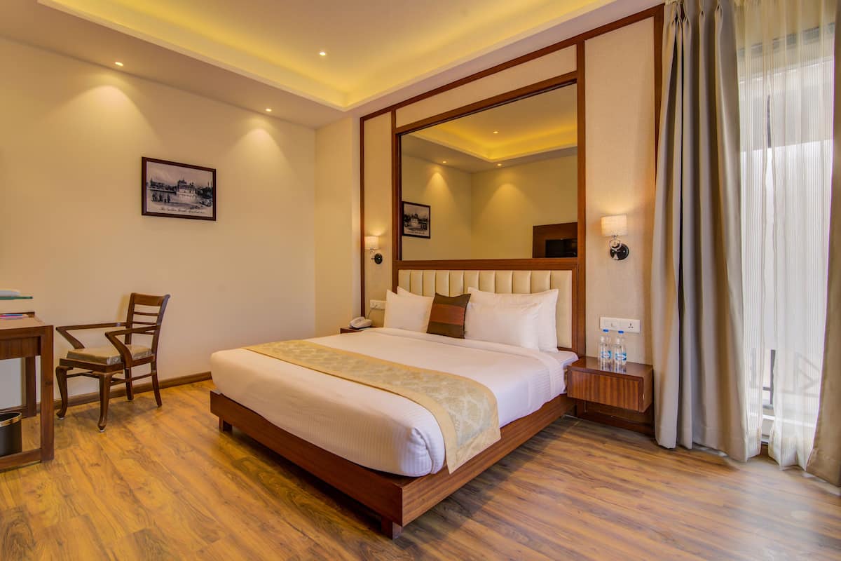 Habitación Deluxe | Ropa de cama de alta calidad y minibar