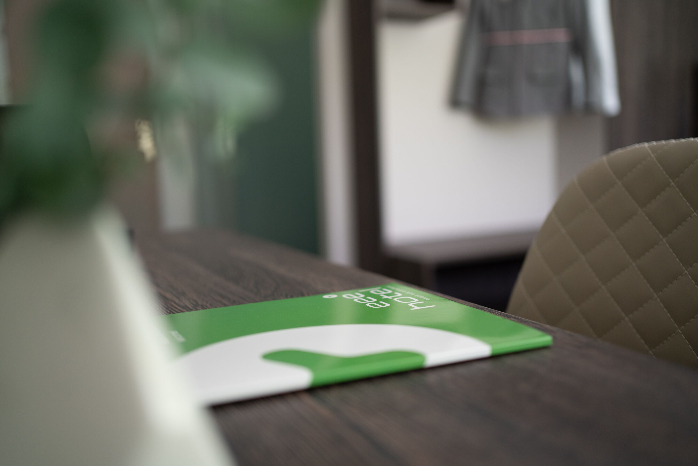 A wooden table with a green and white object on it.