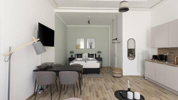 A modern hotel room with a bed, bedside table, and a view of the kitchen.