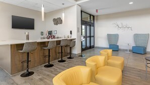 A modern reception area with a bar, seating, and a flat-screen TV. - Best Western Plus Executive Residency Phoenix North Happy Valley (Phoenix)