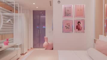 Un dormitorio moderno con una cama blanca, un conejo decorativo rosa y obras enmarcadas en la pared.