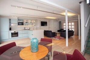 Enjoy a spacious living area with a kitchen, dining, and seating space, perfect for relaxing and socializing.