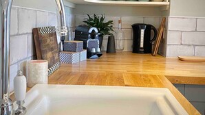 A kitchen with a wooden countertop, a sink, and various kitchen items. - The Georgian Loft Apartment Central Bath (Bath)