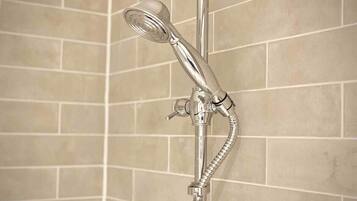A shower with a handheld showerhead and a flexible hose.