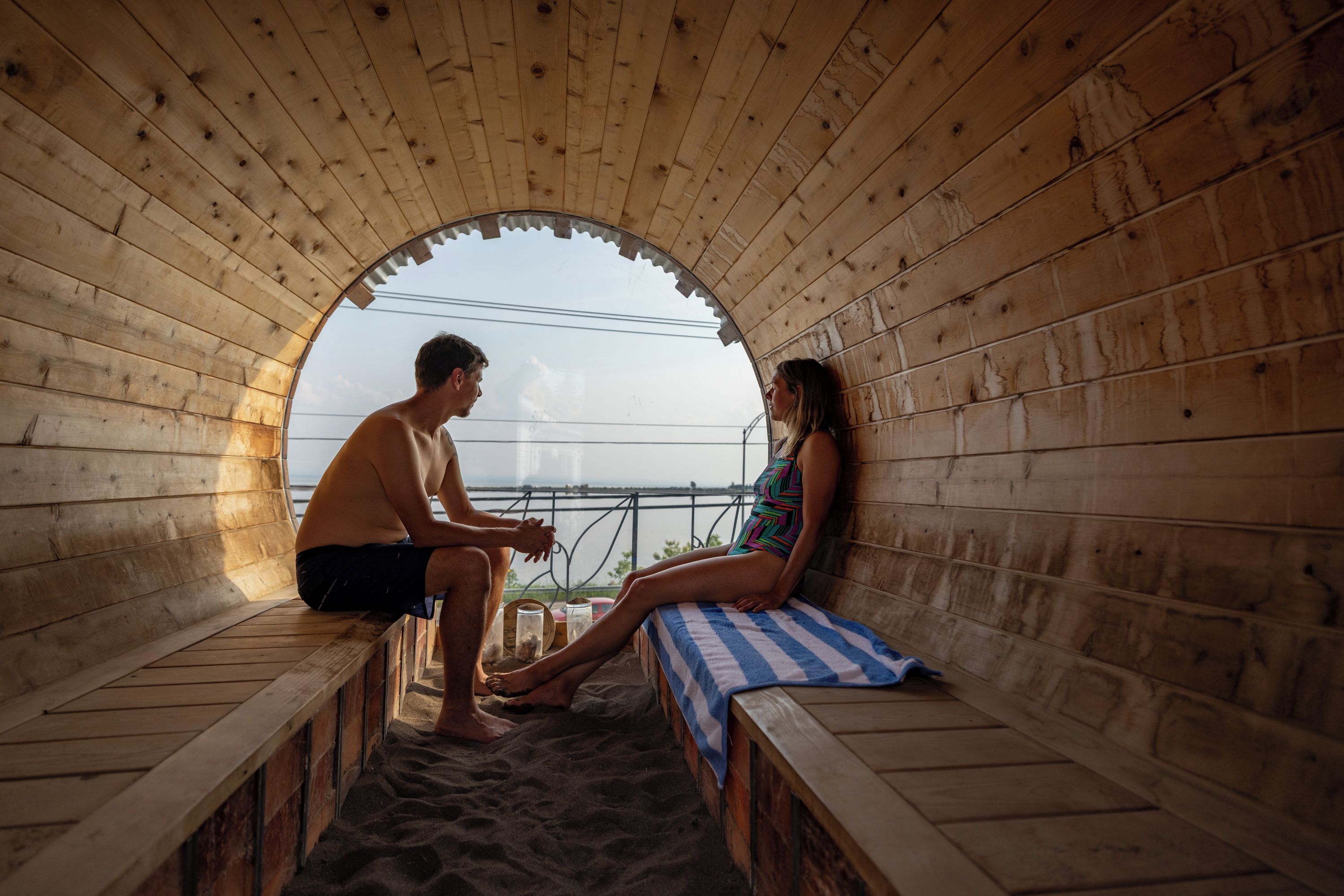 A sauna with wooden walls and a bench.
