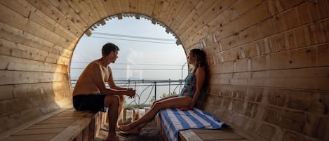 A sauna with wooden walls and a bench.