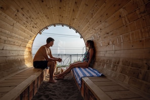 A sauna with wooden walls and a bench.