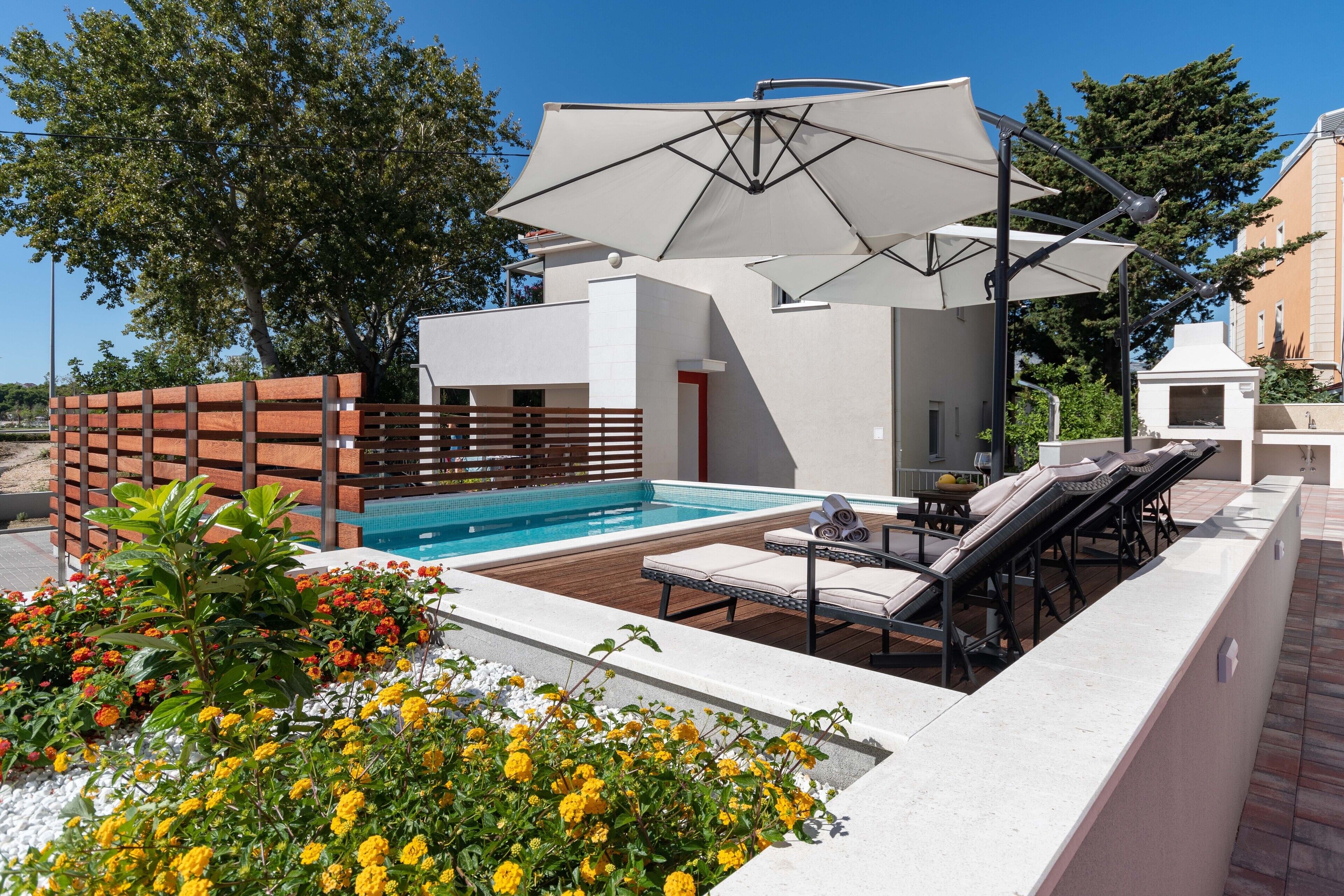 Seasonal outdoor pool, pool umbrellas, pool loungers