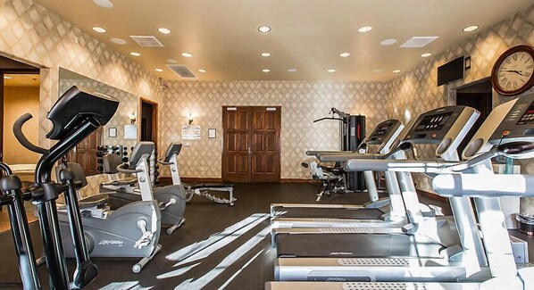 A gym with treadmills, elliptical machines, and stationary bikes.