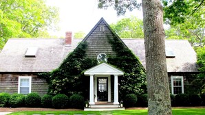 A house with a gabled roof, a front porch, and a chimney. - Beautiful Family Home Nestled In The Heart Of Sagaponack (Sagaponack)