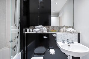 Bathtub, hair dryer, towels, soap