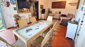 A compact living space with a dining area, kitchenette, and seating area.
