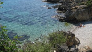 A rocky coastline with clear blue water and a sandy beach. - Villa B, Brio Exclusive | 4BR Seafront Family Villa with Private Pool & Jetty (Kefalonia Islands)
