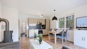 A modern apartment with a kitchen, dining area, and living room.