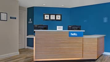 A reception desk with a blue sign reading "hello."