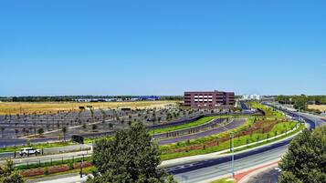 A multi-level highway interchange with a large building in the background.
