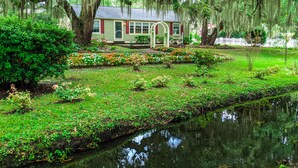 A house with a garden and a pond.