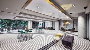 A modern interior with a striped floor, bar area with stools, and seating arrangements. - The Alva Hotel Brisbane, Vignette Collection by IHG (Fortitude Valley)