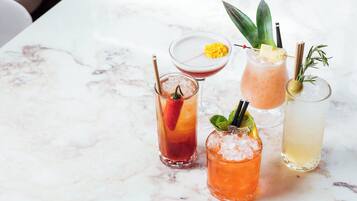 Four cocktails on a marble table.