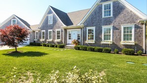 A modern two-story house with a symmetrical design, featuring a central entrance, multiple windows, and a well-maintained lawn. - Chatham Calling... Close to Town & Bocce (Chatham)